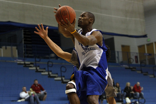 Chris Detrick  |  The Salt Lake Tribune 
Chuck Overton #34 shoots past Chris Medina #20 during the alumni game at Salt Lake Community College Saturday January 15, 2011.  The Old Men team  defeated the Young Men team 71-65 in overtime.