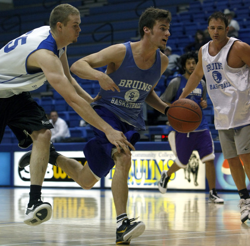 Chris Detrick  |  The Salt Lake Tribune 
Brody Van Brocklin #3 runs past Markus Johnson #55 during the alumni game at Salt Lake Community College Saturday January 15, 2011.  The Old Men team  defeated the Young Men team 71-65 in overtime.