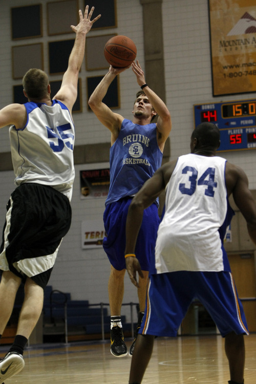 Chris Detrick  |  The Salt Lake Tribune 
Brody Van Brocklin #3 shoots past Markus Johnson #55 and Chuck Overton #34 during the alumni game at Salt Lake Community College Saturday January 15, 2011.  The Old Men team  defeated the Young Men team 71-65 in overtime.