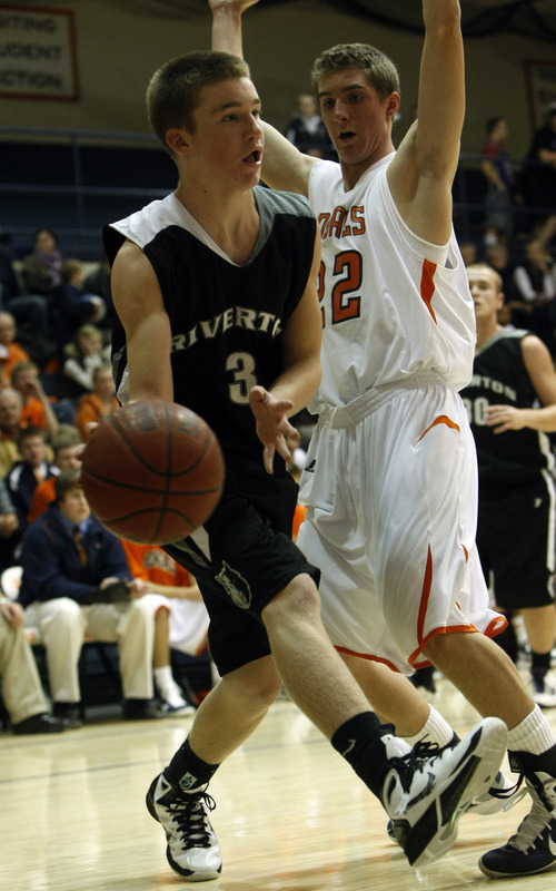 Chris Detrick  |  The Salt Lake Tribune 
Riverton's D McCleary #3 passes around Brighton's Brandon Miller #22 during the game at Brighton High School Tuesday December 14, 2010.