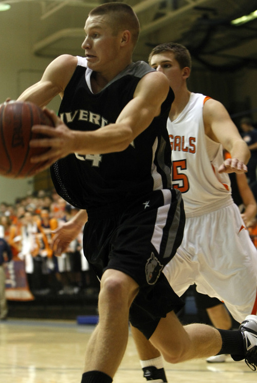 Chris Detrick  |  The Salt Lake Tribune 
Riverton's Stephan Holm #24 runs past Brighton's Corbin Miller #15 during the game at Brighton High School Tuesday December 14, 2010.