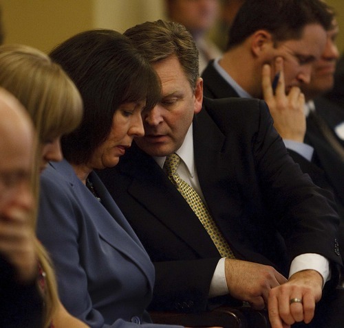 TRENT NELSON | The Salt Lake Tribune
Craig Frank and his wife Kim Frank confer as legislative leaders heard arguments for and against the former lawmaker keeping his seat. They decided he lives outside the district and can not legally represent it.