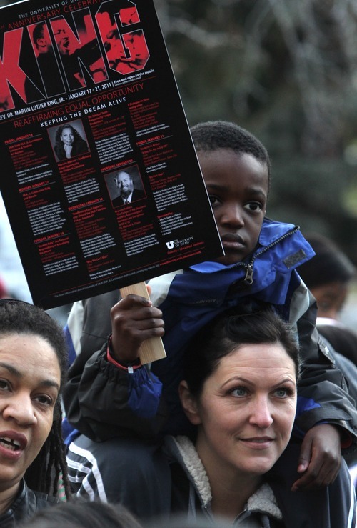 Rick Egan   |  The Salt Lake Tribune

5-year-old Isaac Phillips sits on her mother Marci's  shoulders, at the Park building at the University of Utah during the Martin Luther King Jr. March,  Monday, Jan. 17, 2011.