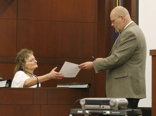 Paul Fraughton  |  The Salt Lake Tribune  Prosecutor, Scott Reed  hands Debra Brown a transcript of statements she made to police fifteen years ago during the investigation of  the murder of Lael Brown. Debra Brown was on the witness stand at her  hearing in Ogden's second district court  on  Friday,January 21, 2011