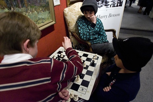 Djamila Grossman  |  The Salt Lake Tribune
Andrew Roach, 8, left, of North Salt Lake, Sam Mason, 10, of Park City, and Nektarios Mantas, 10, of Salt Lake City, play chess at the Thomas Kearns McCarthey Gallery in Park City Friday. The young players matched wits with each other and with grandmasters at the premiere of 