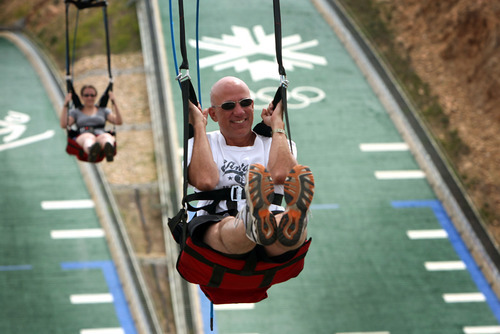 Pennsylvanian Steve Wooldridge and his daughter, Rachael, race down the Xtreme Zip at Utah Olympic Park, one of the activities the Utah Athletic Foundation has promoted to expose people to the enjoyment of outdoor recreation, Olympic-style. Tribune file photo