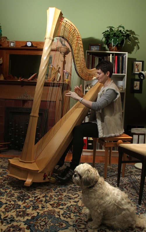 Rick Egan   |  The Salt Lake Tribune

Ollie listens as Louise Vickerman, the Utah Symphony's principal harpist, plays in her home,  Monday, Dec. 27, 2010. Vickernam will perform 