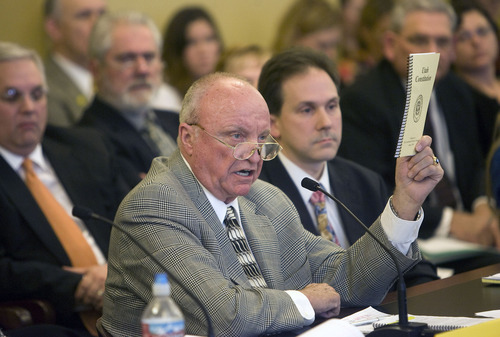 Al Hartmann  |  The Salt Lake Tribune 
Senator Chris Buttars waves a copy of the Utah Constitution in front of the members of the Senate Education Standing Committee on Wednesday.  He is proposing SJR001 Joint Resolution, a constitutional amendment that would give the Legislature control over the State Board of Education.