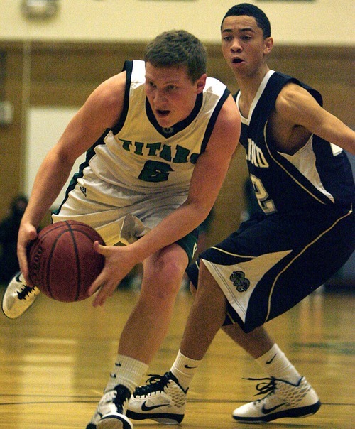 Djamila Grossman  |  The Salt Lake Tribune

Olympus High School's Tanner Curtis, 2, stumbles as Highland High School's Liam Thomas, 22, watches, during a game at Olympus, Friday, Jan. 28, 2011.