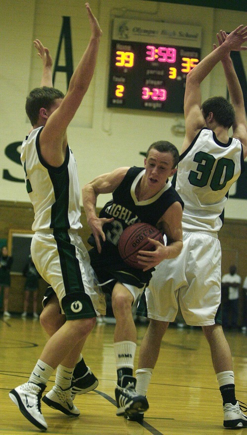 Djamila Grossman  |  The Salt Lake Tribune

Highland High School's Sam Orchard, 3, pushes past Olympus High School's Will Cannon, 30, and Tanner Curtis, 2, during a game at Olympus, Friday, Jan. 28, 2011. Highland won the game.