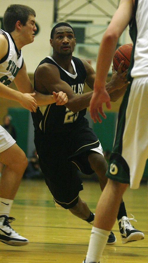 Djamila Grossman  |  The Salt Lake Tribune

Highland High School's Nate Fakahafua, 23, drives toward the basket during a game against Olympus High School at Olympus, Friday, Jan. 28, 2011. Highland won the game.