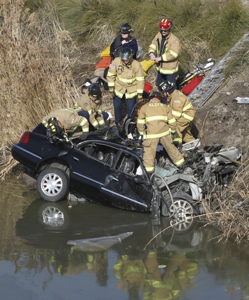 Rick Egan   |  The Salt Lake Tribune

Firefighters work Friday to remove the body of the driver of a car that flew over the pond from the off ramp from I-15 to 2100 South and smashed into a dirt embankment. The driver was identified as 21-year-old Maria L. Mejia.