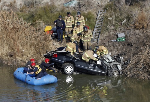 Rick Egan   |  The Salt Lake Tribune

Firefighters work Friday to remove the body of the driver of a car that flew over the pond from the off ramp from I-15 to 2100 South and smashed into a dirt embankment. The driver was identified as 21-year-old Maria L. Mejia.