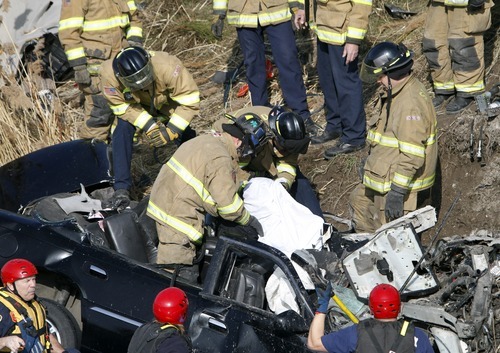 Rick Egan   |  The Salt Lake Tribune

Firefighters work Friday to remove the body of the driver of a car that flew over the pond from the off ramp from I-15 to 2100 South and smashed into a dirt embankment. Troopers estimate the car dropped vertically about 70 feet from the off-ramp to the embankment below. The driver was identified as 21-year-old Maria L. Mejia. Police aren't sure when the accident happened and have no witnesses.