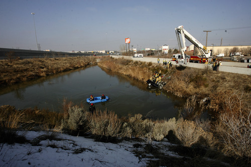 Rick Egan   |  The Salt Lake Tribune

Firefighters work Friday to remove the body of the driver of a car that flew over the pond from the off ramp from I-15 to 2100 South and smashed into a dirt embankment. The driver was identified as 21-year-old Maria L. Mejia. Police aren't sure when the accident happened and have no witnesses.
