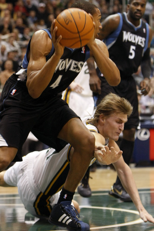 Chris Detrick  |  The Salt Lake Tribune 
Minnesota Timberwolves small forward Wesley Johnson #4 and Utah Jazz small forward Andrei Kirilenko #47 go for the ball during the first half of the game at EnergySolutions Arena Friday January 28, 2011.