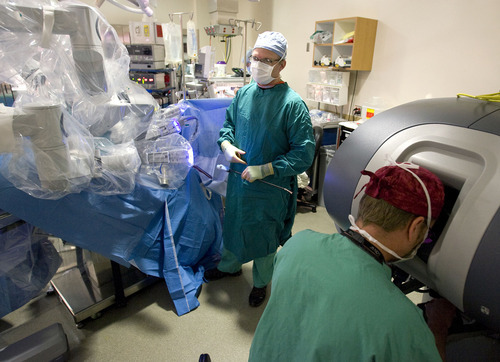 Al Hartmann  |  The Salt Lake Tribune
Dr. Michael Mangleson, right, performs a prostate procedure using robotic arms Friday as Jeff Piacitelli monitors the patient at Intermountain Medical Center in Murray.