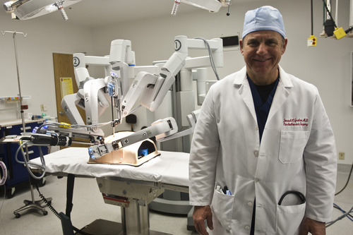 Chris Detrick  |  The Salt Lake Tribune 
Cardiovascular surgeon Joseph Graham poses Wednesday for a portrait with the da Vinci surgical system at Ogden Regional Medical Center.