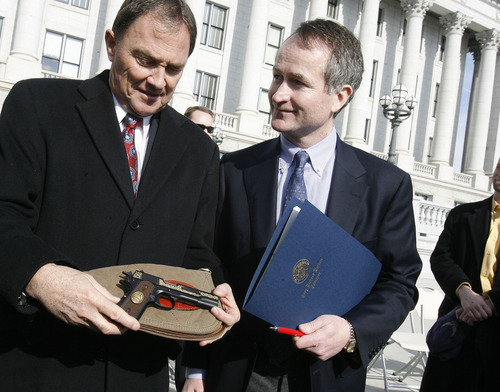 Scott Sommerdorf  l  The Salt Lake Tribune
Utah Gov. Gary Herbert, left, holds the commemorative .22 cal Browning handgun given to him by Christopher Browning, right, the great-grandson of John M. Browning, Jan. 24. The Governor made a formal presentation of the resolution declaring January 24, 2011 as John M. Browning Day during a noon ceremony on the Capitol steps.