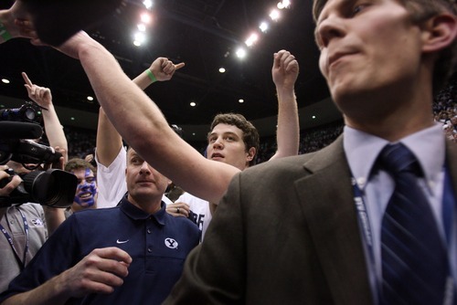 Steve Griffin  |  The Salt Lake Tribune
 
BYU guard Jimmer Fredette is proteted by security as fans storm the court following BYU's vitory over San Diego State men's basketball game at the Marriott Center in Provo Wednesday, January 26, 2011.