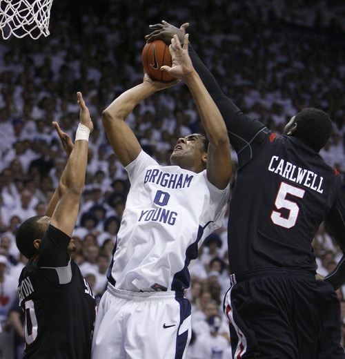 Steve Griffin  |  The Salt Lake Tribune
 
BYU forward Brandon Davies gets his shot blocked by San Diego State center Brian Carlwell during first half action of the BYU versus San Diego State men's basketball game at the Marriott Center in Provo Wednesday, January 26, 2011.
