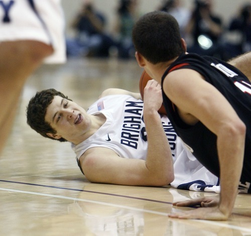 Steve Griffin  |  The Salt Lake Tribune
 
BYU guard Jimmer Fredette gets knocked to the ground by San Diego State guard James Rahon during first half action of the BYU versus San Diego State men's basketball game at the Marriott Center in Provo Wednesday, January 26, 2011.