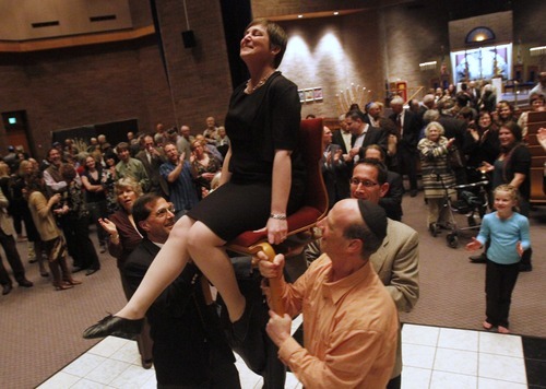 Rick Egan   |  The Salt Lake Tribune
Ilana Schwartzman is lifted up on a chair after installed as senior rabbi, during a special 