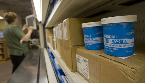 Al Hartmann   |  The Salt Lake Tribune 
The University Hospital data bank protects patients from nationwide drug shortages.  A pharmacy technician at the University Pharmacy pulls medications from a carousel that are in high demand.  The carousel system helps the pharmacy keep closer track of inventory.  They try help in drug loans with other hospitals as much as possible but don't want to run short for their own demand.