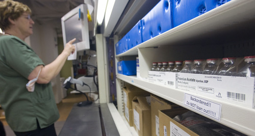 Al Hartmann   |  The Salt Lake Tribune 
The University Hospital data bank protects patients from nationwide drug shortages.  A pharmacy technician at the University Pharmacy pulls medications from a carousel that are in high demand.  The carousel system helps the pharmacy keep closer track of inventory.  They try help in drug loans with other hospitals as much as possible but don't want to run short for their own demand.