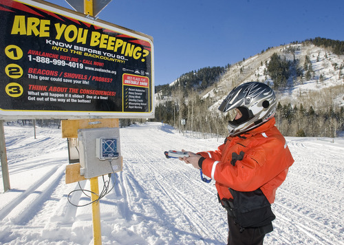 Al Hartmann  |  The Salt Lake Tribune 
Joe Donnell of Utah State Parks checks his avalanche beacon at station trailhead for the  Mill Hollow Snowmobile Complex east of Woodland.