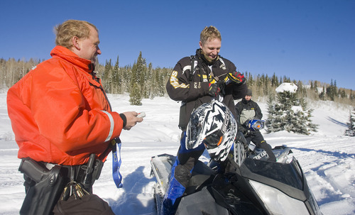 Al Hartmann  |  The Salt Lake Tribune 
Joe Donnell of Utah State Parks patroling the high country of the  Mill Hollow Snowmobile Complex east of Woodland stops to chat with experienced snowmobiler Mark Menlove of Draper and asks him to check his avalanche beacon.