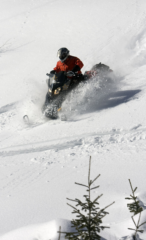 Al Hartmann  |  The Salt Lake Tribune 
Joe Donnell of Utah State Parks tests a steep and deep slope as he patrols the high country of the  Mill Hollow Snowmobile Complex east of Woodland.