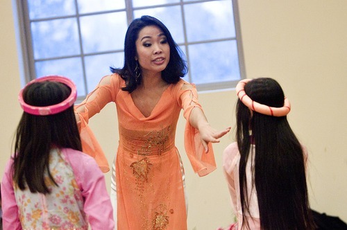 Djamila Grossman  |  The Salt Lake Tribune
The Vietnamese Community in Utah is celebrating the lunar New Year with a big festival. Choreographer Thai Huong talks to 10-year-old Emily Nguyen, right, and Rose Nguyen, 8, Sunday at Lien Hoa Buddhist Temple as they practice a dance they will be performing during the festival.