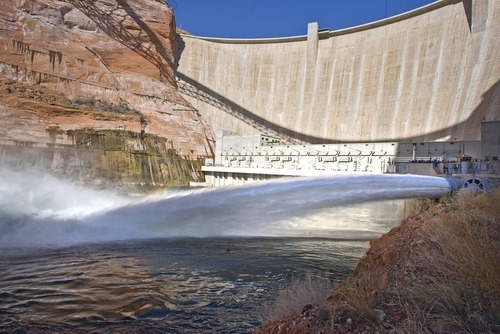 Media and invited guests watch as the large valves are opened at the base of the Glen Canyon Dam on Wednesday, March 5, 2008, sending water at a rate of 41,00 cubic feet per second into the Colorado River. 
Paul Fraughton /The Salt Lake Tribune; 3/5/08