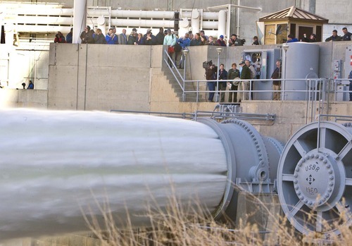 Media and invited guests watch as the large valves are opened at the base of the Glen Canyon Dam on Wednesday, March 5, 2008, sending water at a rate of 41,00 cubic feet per second into the Colorado River. 
Paul Fraughton /The Salt Lake Tribune; 3/5/08