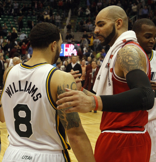 Rick Egan  |  The Salt Lake Tribune

Deron Williams gives Carlos Boozer a hug after the Jazz were defeated by the Bulls, in Salt Lake City, Wednesday, February 9, 2011
