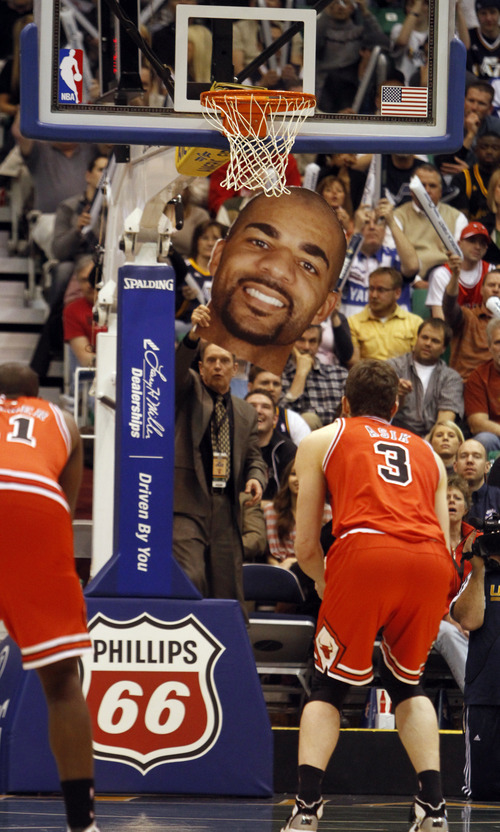 Rick Egan  |  The Salt Lake Tribune

Richard Anderson uses a giant cut out of Carlos Boozer, as he attempts to distract the Bulls' Omer Asik, as he shoots a foul shot, in NBA action Utah vs. Chicago, in Salt Lake City, Wednesday, February 9, 2011