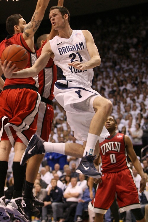Leah Hogsten  |  The Salt Lake Tribune
BYU forward Stephen Rogers (21) passes off underneath the basket.
The Brigham Young University Cougars defeated UNLV Saturday, February 5, 2011, in Provo, 78-64 at the Marriott Center.