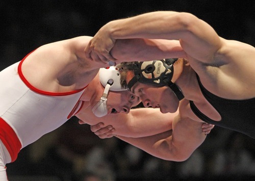 Rick Egan   |  The Salt Lake Tribune

Jaxon Singleton, Delta, (white) wrestles Jalen Weaver, Deseret Hills (black) for the 3A state wrestling title, in the 171weight class, in Orem, Saturday, February 12, 2011.