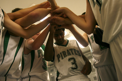 Chris Detrick  |  Tribune file photo
Sophomore Kunal Sah huddles with his teammates in the locker room at half time during the J.V. basketball game against Meridian at Green River High School Dec. 17, 2008. His parents, Ken and Sarita Sah, were denied political asylum and deported back to India in 2006. 