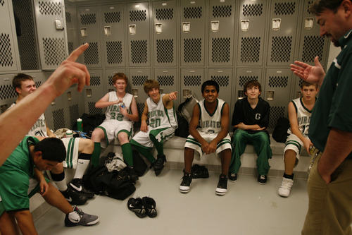 Sophomore Kunal Sah, center, listens to Assistant coach Rob Maughan, right, at half time in the locker room during the J.V. basketball game against Meridian at Green River High School Wednesday December 17, 2008.  
His parents Kanhai and Sarita were denied political asylum and deported back to India in 2006, so Kunal lives with his uncle and aunt at the Ramada Limited Motel.

