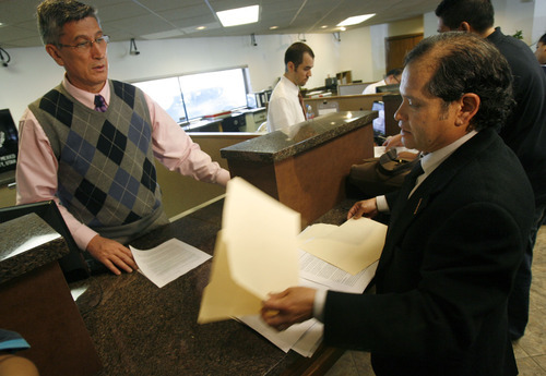 Francisco Kjolseth  |  The Salt Lake Tribune
Mexican consulate official Jose Umberto Gutierrez, left, accepts a letter from Raul Lopez-Vargas containing 135 signatures at the Mexican Consulate in Salt Lake City Monday. The petition asks the Mexican president to suspend visas to Mormon missionaries until the LDS Church takes a stronger stand on immigration reform.