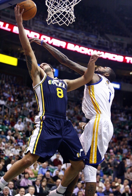 Djamila Grossman  |  The Salt Lake Tribune

The Utah Jazz's Deron Williams (8) gets blocked by the Golden State Warriors' Dorell Wright (1) during a game in Salt Lake City on Wednesday, Feb.16, 2011. The Jazz lost the game.