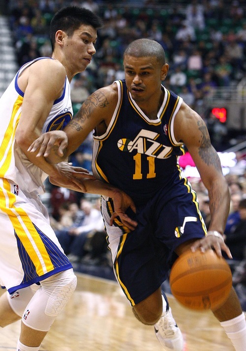 Djamila Grossman  |  The Salt Lake Tribune

The Utah Jazz's Earl Watson (11) drives past the Golden State Warriors'  Jeremy Lin (7) during a game in Salt Lake City on Wednesday, Feb.16, 2011. The Jazz lost the game.