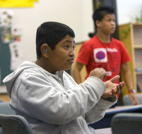 Al Hartmann   |  The Salt Lake Tribune 
Argenis Valentin, a ninth-grader at Jean Massieu School of the Deaf, answers a question in his earth science class using American Sign Language. He is one of 100 students at the Millcreek school.