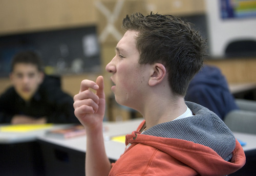 Al Hartmann   |  The Salt Lake Tribune 
Bryce Jackson, a ninth-grader at Jean Massieu School of the Deaf, answers a question in his earth science class using American Sign Language. He is one of 100 students at the Millcreek school.