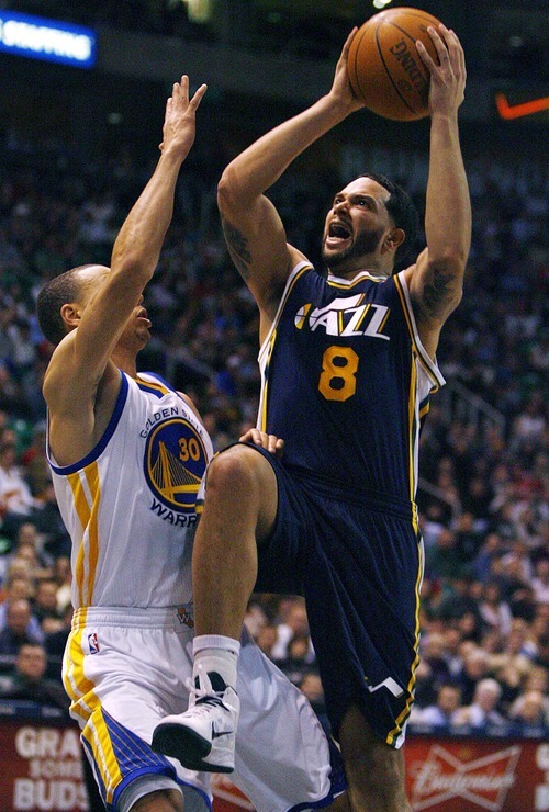 Djamila Grossman  |  The Salt Lake Tribune

Deron Williams (8) shoots past the Warriors' Stephen Curry (30) during a game in Salt Lake City on Wednesday, Feb.16, 2011. A deal is in the works Wednesday for the Jazz to trade Williams to the New Jersey Nets for two players, two draft picks and cash in a shocking NBA trade.