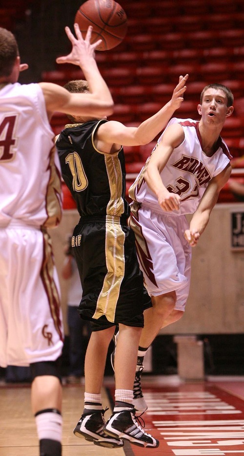 Leah Hogsten  |  The Salt Lake Tribune
Cedar's Kyler Nielson throws past Wasatch's Matt Pelo to teammate Trent Snow. 
 Wasatch High School defeated  Cedar High School 53-43 during their 3A High School Championship quarterfinals at the Jon M. Huntsman Center on the University of Utah campus on Thursday, Feb. 24, 2011.