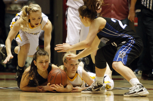 Rick Egan   |  The Salt Lake Tribune

Tia Pappas (20) Carbon High goes in for the ball, as Miranda Averett (23) Carbon High wrestles for control along with Emery's Blayr Jeffs (5) and Tayler Jewkes (3) in 3A girls state basketball championship game, Carbon vs. Emery, at Huntsman Center, Saturday, February 26, 2011