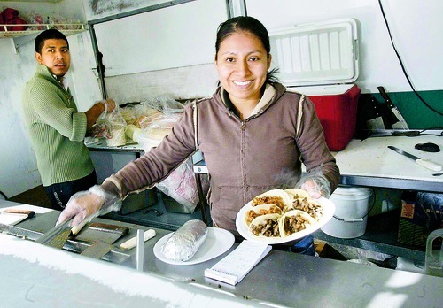 Paul Fraughton  |  The Salt Lake Tribune  Maria Santiago, who runs a Mexican food wagon on Redwood Road near 3500 South,  works with Ricardo Ordonez serving food to a diverse clientele.